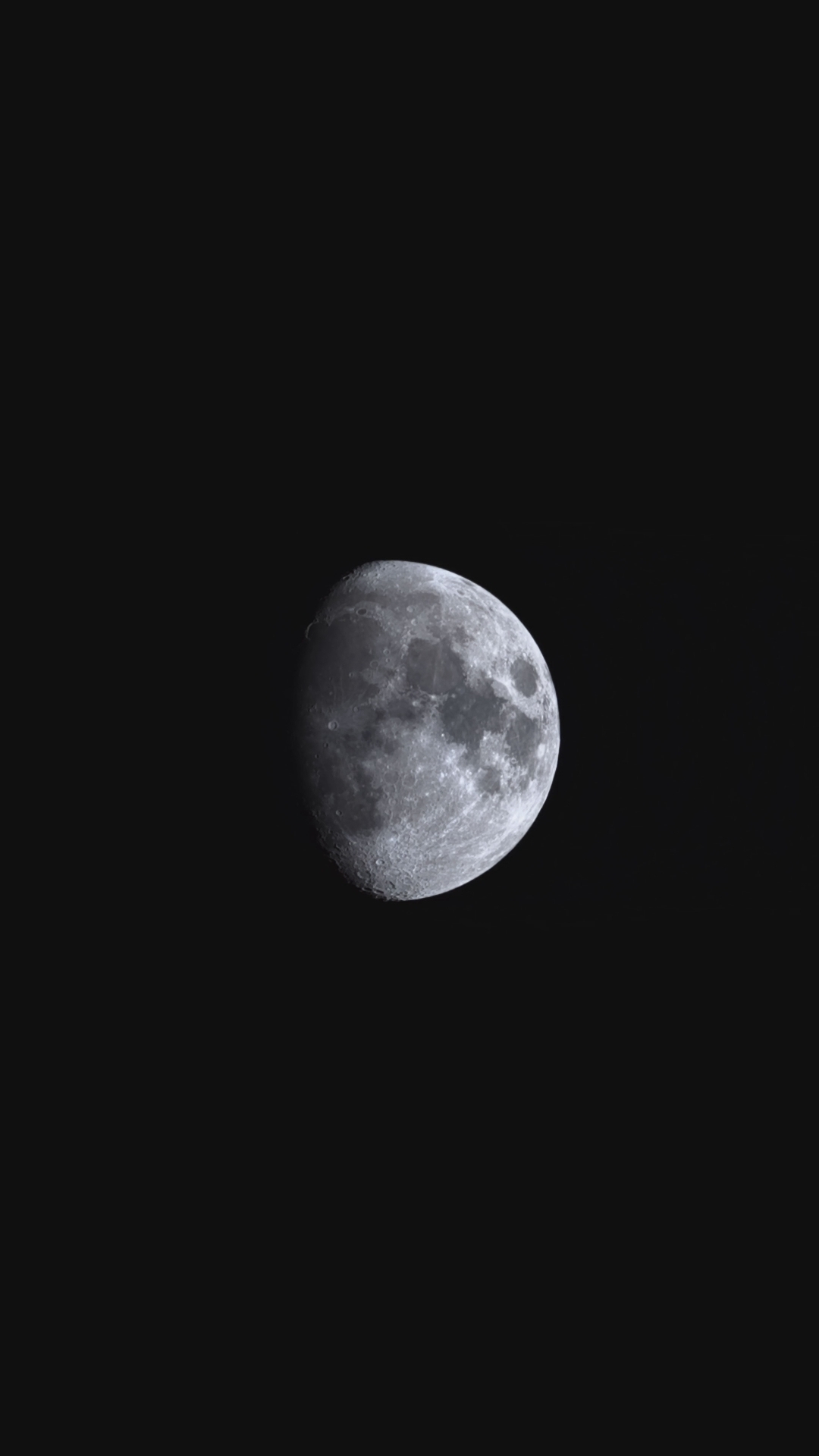 Auto-generated description: A detailed photograph of the moon shows its craters and surface features against a black sky.